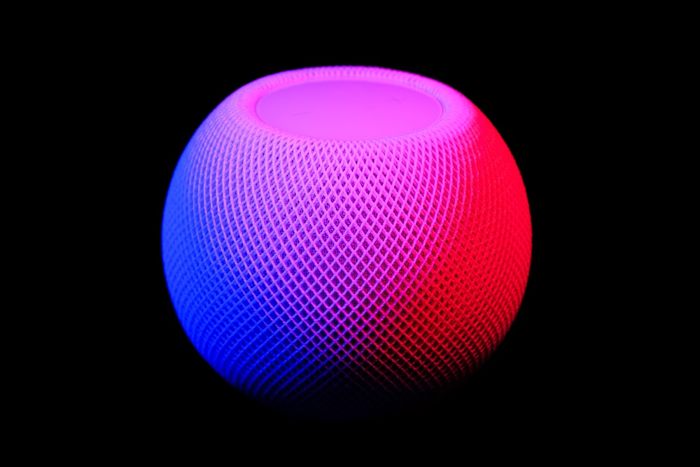 A smart speaker glowing with colorful ambient light